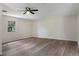 Spacious bedroom featuring a new floor, a ceiling fan, and a window at 10441 Mayflower Rd, Spring Hill, FL 34608