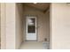 Close-up of home's entrance featuring white door, stone accents, and well-kept landscaping at 10441 Mayflower Rd, Spring Hill, FL 34608