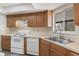 Efficient kitchen features ample cabinet storage, smooth countertops, and white appliances at 10441 Mayflower Rd, Spring Hill, FL 34608