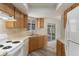 Efficient kitchen features ample cabinet storage, smooth countertops, and white appliances at 10441 Mayflower Rd, Spring Hill, FL 34608