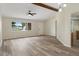 Open living room boasts neutral walls, stylish ceiling fan, and sleek wood-look flooring at 10441 Mayflower Rd, Spring Hill, FL 34608