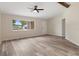 Open living room boasts neutral walls, stylish ceiling fan, and sleek wood-look flooring at 10441 Mayflower Rd, Spring Hill, FL 34608