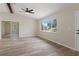 Open living space with beamed ceiling and sliding glass doors at 10441 Mayflower Rd, Spring Hill, FL 34608