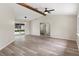 Open living space with beamed ceiling, modern furnishings, and sliding glass doors at 10441 Mayflower Rd, Spring Hill, FL 34608