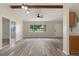 Open living room boasts neutral walls, stylish ceiling fan, and sleek wood-look flooring at 10441 Mayflower Rd, Spring Hill, FL 34608