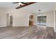 Open living space with beamed ceiling, sliding glass doors to pool, and view of kitchen at 10441 Mayflower Rd, Spring Hill, FL 34608