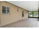 A covered patio area with tiled flooring and natural light at 10441 Mayflower Rd, Spring Hill, FL 34608
