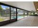 A screened-in pool area with outdoor seating and a view of the backyard at 10441 Mayflower Rd, Spring Hill, FL 34608