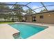The home's screened-in pool area features a patio and a refreshing pool at 10441 Mayflower Rd, Spring Hill, FL 34608