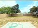 Spacious backyard with a concrete slab and wooden fence at 11034 Harding Dr, Port Richey, FL 34668