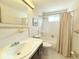 Clean bathroom features a tub and shower combo with a large mirror at 11034 Harding Dr, Port Richey, FL 34668