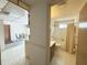 A doorway reveals a traditional bathroom with a shower-tub combo and neutral color palette at 11034 Harding Dr, Port Richey, FL 34668