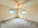 Bright bedroom with carpet flooring, ceiling fan, and ample natural light at 11034 Harding Dr, Port Richey, FL 34668