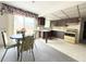 Eat-in kitchen features neutral decor, backyard views and access, plus ample cabinet space at 11034 Harding Dr, Port Richey, FL 34668