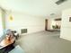 Open-concept living room, neutral carpet, with an eat in dining area and natural light at 11034 Harding Dr, Port Richey, FL 34668