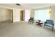 Bright living room with neutral carpeting, ample natural light, and classic decor at 11034 Harding Dr, Port Richey, FL 34668