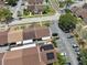 Organized townhome community featuring dedicated parking, energy-efficient solar panels, and well-maintained green spaces from above at 11402 Shallowbrook Pl, Tampa, FL 33624