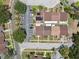 Aerial view of townhomes showcasing organized parking, modern solar panels, and neatly arranged green spaces under sunny skies at 11402 Shallowbrook Pl, Tampa, FL 33624