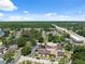 Lush community featuring a serene lake, organized townhomes, easy highway access, and ample parking under a clear sky at 11402 Shallowbrook Pl, Tampa, FL 33624