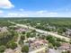 Scenic community featuring a tranquil lake, well-placed townhomes, easy highway access, and abundant parking under blue skies at 11402 Shallowbrook Pl, Tampa, FL 33624