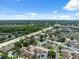 Sprawling community featuring lush greenery, well-maintained townhomes, and convenient parking under a clear blue sky at 11402 Shallowbrook Pl, Tampa, FL 33624