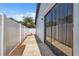 Backyard view featuring a narrow paver area and full sliding glass door to the home at 11402 Shallowbrook Pl, Tampa, FL 33624