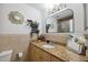 Well-lit bathroom with a granite countertop and decorative mirror at 11402 Shallowbrook Pl, Tampa, FL 33624