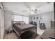 Comfortable bedroom with a ceiling fan, natural light and tile flooring at 11402 Shallowbrook Pl, Tampa, FL 33624