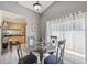Bright dining area featuring a glass table, tile flooring, and sliding glass doors at 11402 Shallowbrook Pl, Tampa, FL 33624