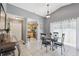 Bright dining room with tile flooring, large window, and seating for four at 11402 Shallowbrook Pl, Tampa, FL 33624