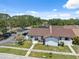 Aerial view of home featuring front yard, parking area, mature trees, and manicured landscaping at 11402 Shallowbrook Pl, Tampa, FL 33624