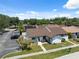 Aerial view of home featuring front yard, parking area, mature trees, and landscaping at 11402 Shallowbrook Pl, Tampa, FL 33624