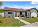 Inviting single-story home featuring a well-maintained lawn and neutral exterior paint at 11402 Shallowbrook Pl, Tampa, FL 33624