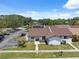 Aerial view of home with manicured front yard, mature landscaping, and community parking at 11402 Shallowbrook Pl, Tampa, FL 33624