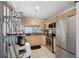 Functional kitchen featuring stainless steel appliances and light wood cabinets at 11402 Shallowbrook Pl, Tampa, FL 33624