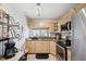 Kitchen featuring stainless steel appliances, granite countertops, and light wood cabinets at 11402 Shallowbrook Pl, Tampa, FL 33624
