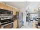 Kitchen featuring stainless steel appliances, granite countertops, and light wood cabinets at 11402 Shallowbrook Pl, Tampa, FL 33624