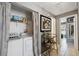 Functional laundry area with a washer, dryer, and storage shelving at 11402 Shallowbrook Pl, Tampa, FL 33624