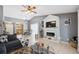 Open-concept living room featuring a decorative fireplace, tiled floors, and view into the adjacent dining area at 11402 Shallowbrook Pl, Tampa, FL 33624