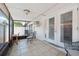 Tile patio featuring white french doors, patio furniture, and a screened view of the yard at 11402 Shallowbrook Pl, Tampa, FL 33624