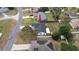 Home aerial showing fenced backyard, clean roof, and nearby homes at 11494 Villa Rd, Spring Hill, FL 34609