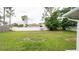 Large backyard features green grass and a white fence at 11494 Villa Rd, Spring Hill, FL 34609