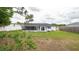 Fenced backyard includes green grass and partial home view at 11494 Villa Rd, Spring Hill, FL 34609