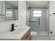Modern bathroom featuring a sliding glass shower door and stylish vanity with a matte black faucet at 11494 Villa Rd, Spring Hill, FL 34609