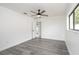 Spacious bedroom with a ceiling fan and wood-look floors at 11494 Villa Rd, Spring Hill, FL 34609