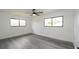 Bedroom featuring new floors, ceiling fan, and multiple windows at 11494 Villa Rd, Spring Hill, FL 34609