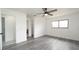 Bedroom featuring new floors, ceiling fan, and window at 11494 Villa Rd, Spring Hill, FL 34609