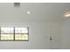 A bright room with a window and modern white door at 11494 Villa Rd, Spring Hill, FL 34609