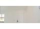 Bright entryway showcases a modern white door, window and white walls at 11494 Villa Rd, Spring Hill, FL 34609