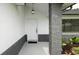 Inviting front entrance with modern light fixture and decorative concrete pillar at 11494 Villa Rd, Spring Hill, FL 34609
